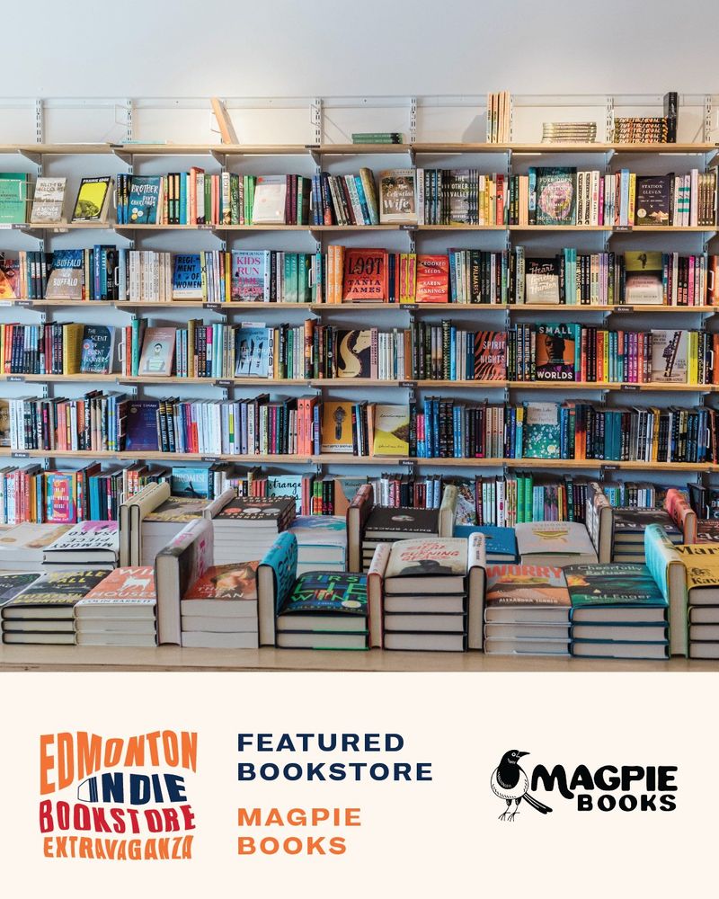 Interior of Magpie Books in Edmonton, showing white walls with bookshelves full of books. In the foreground, more books stacked on a table.