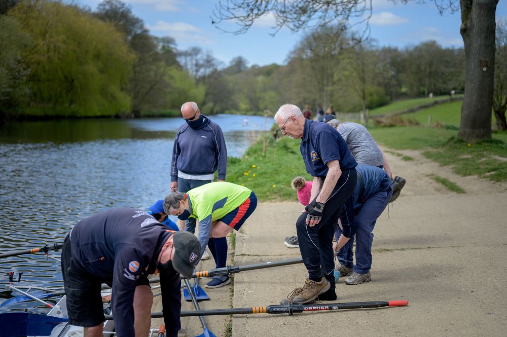 group of men preparing to get into the water on small boats