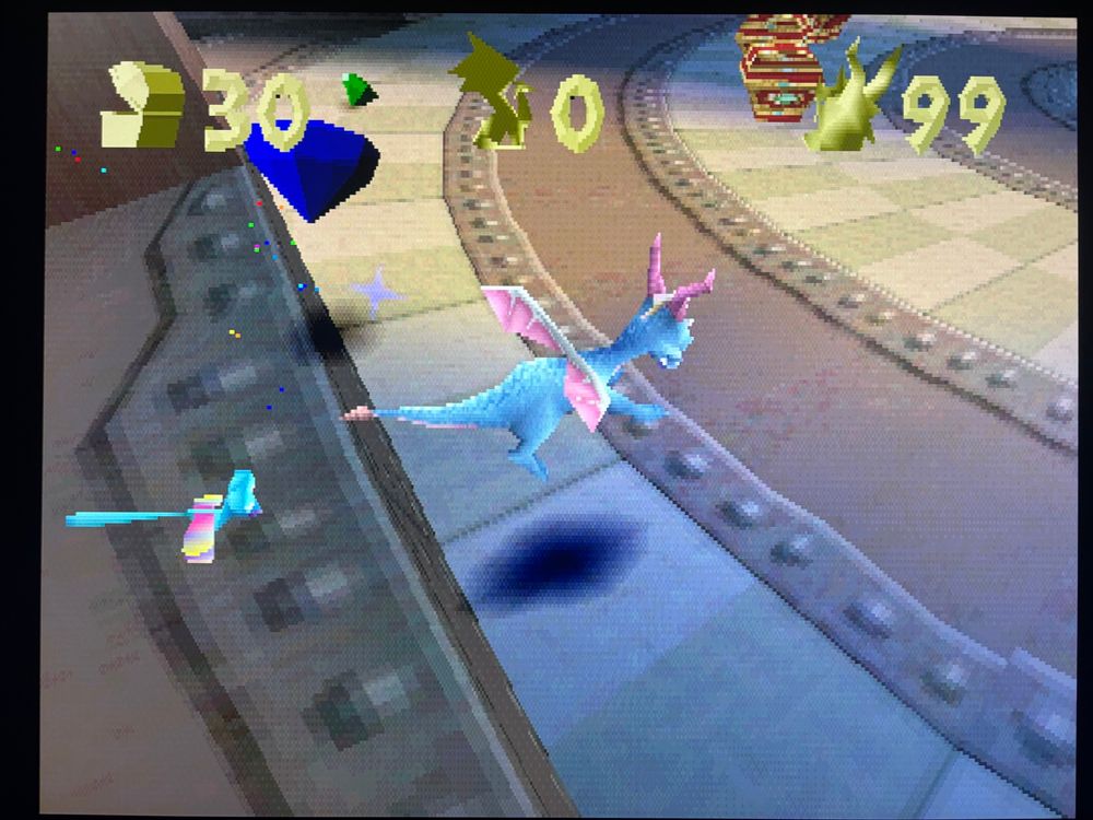 A still image of Spyro the dragon in the trans color theme charging forward.