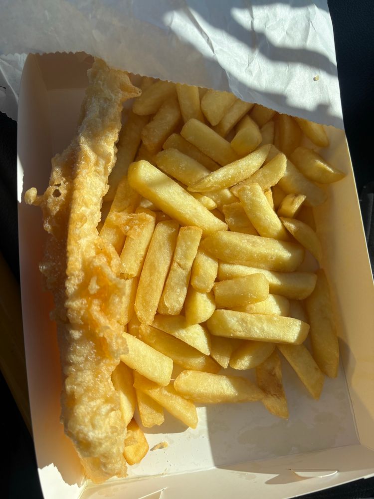Fish and chips in a white cardboard tray