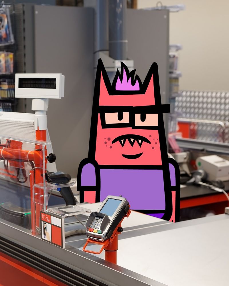 The teen from Devils and the Details stands behind a check out counter and stares unhappily.