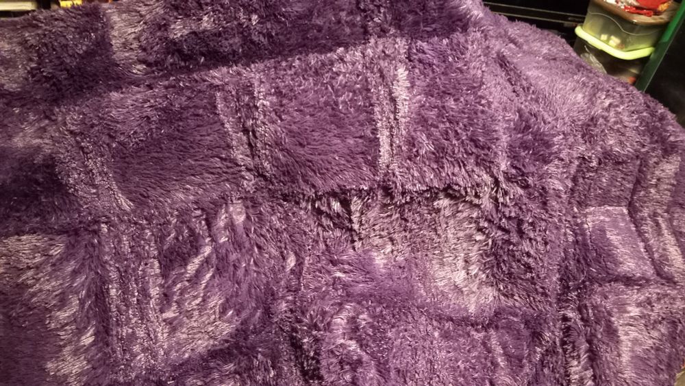 Purple ~Rug unfolded and laying over a bunch of crap