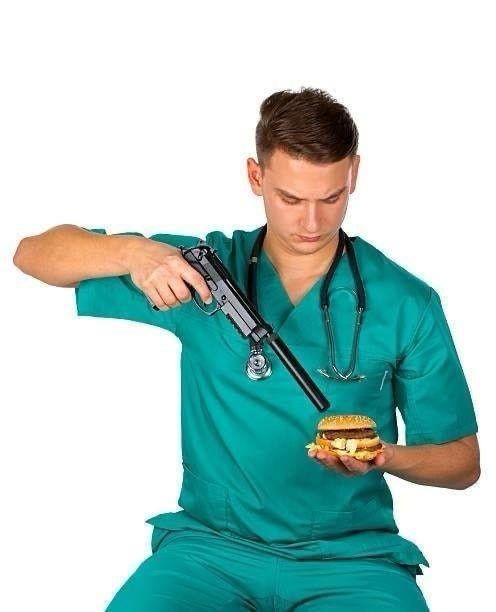 Stock photo:
A man in scrubs with a stethoscope draped over his shoulders points a suppressed handgun at a burger resting on the flat of his palm.

Which seems like a great way to shoot your own hand.