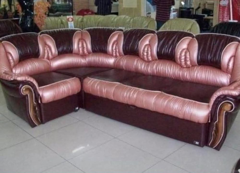 An odd looking couch where the seams between the back cushions look suspiciously like vaginas