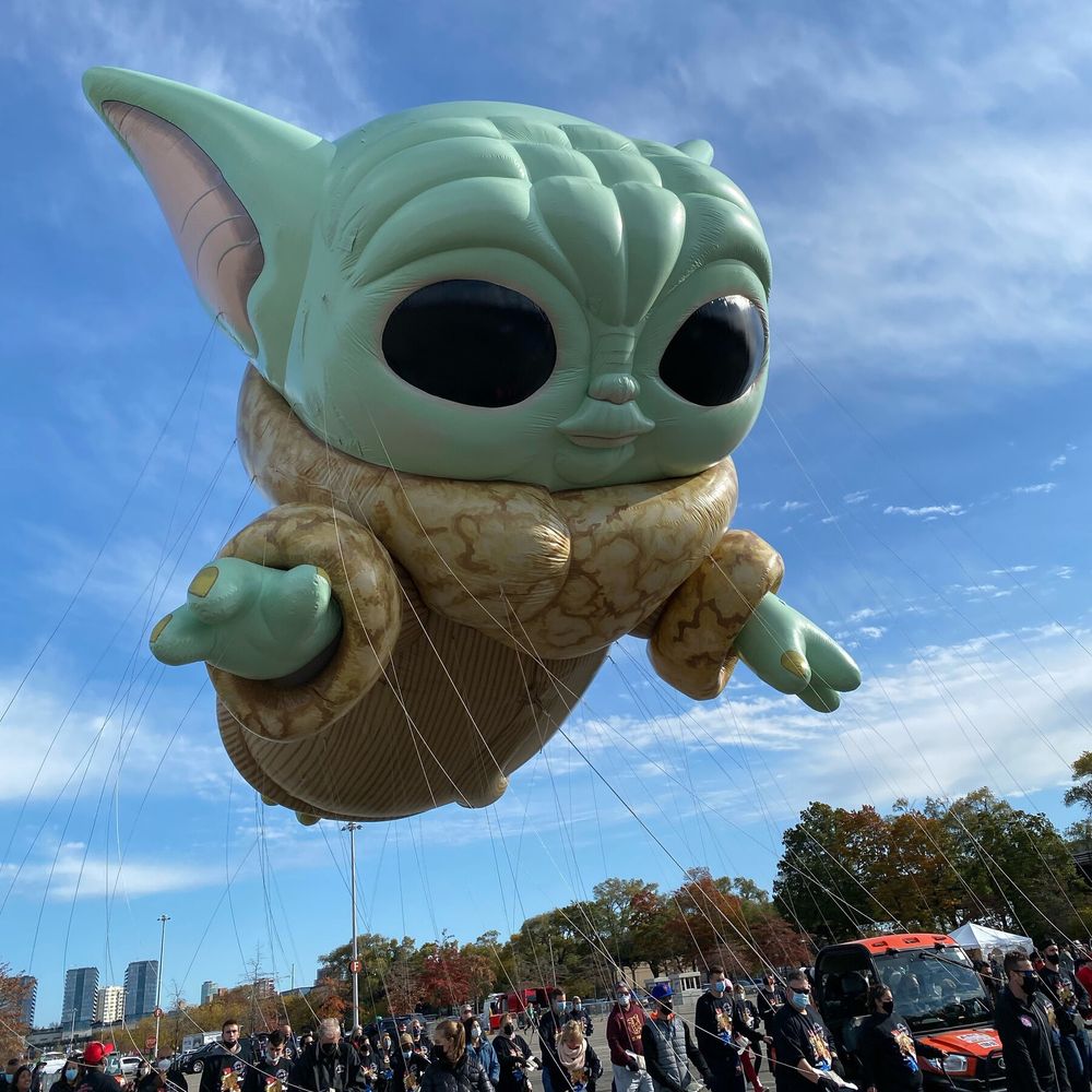 Photo of giant inflatable baby Grogu at parade.