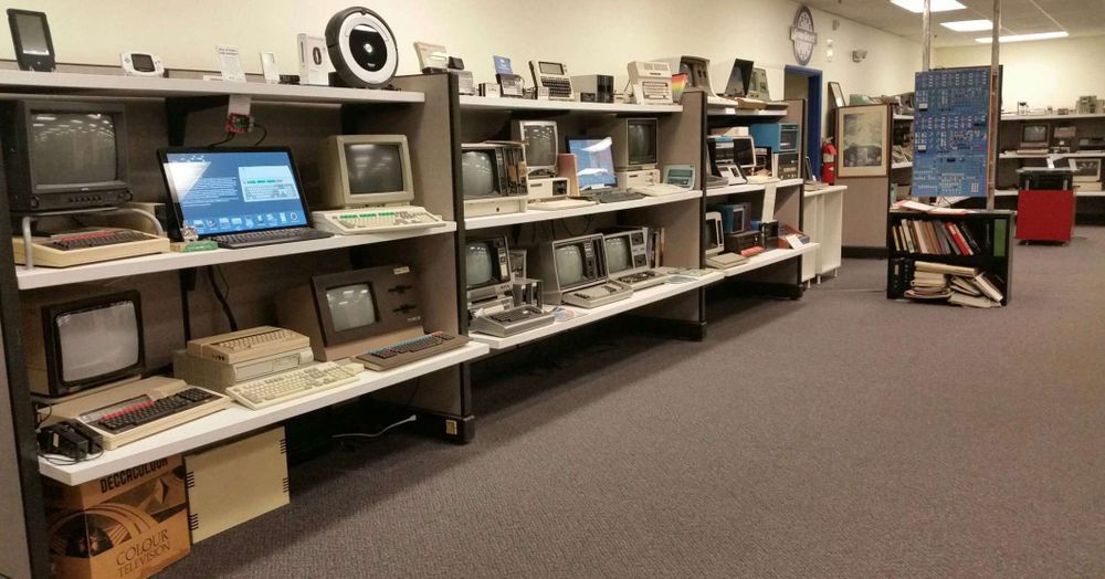three exhibits featuring acorns, tandy machines, s-100 bus machines, and some commodores in the distance