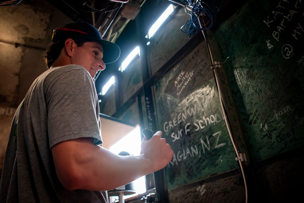 Roman Anthony smiles as he signs inside the Monster at Fenway Park.