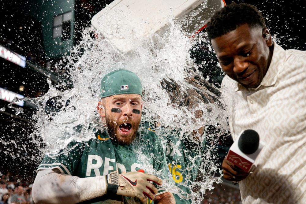 Trevor Story gets dumped with Gatorade after hitting a walk-off single to beat the Marlins at Fenway Park. He is wearing the Red Sox Fenway Greens uniforms.