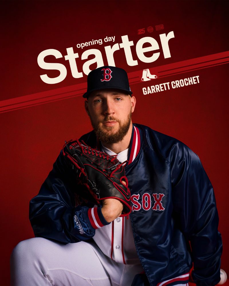 TEXT: Opening Day Starter - Garrett Crochet

IMAGE: Garrett Crochet poses in a Red Sox home white uniform and a navy blue Red Sox jacket in front of a red background. He is holding his glove.
