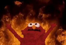 elmo from sesame street is on fire with his arms outstretched