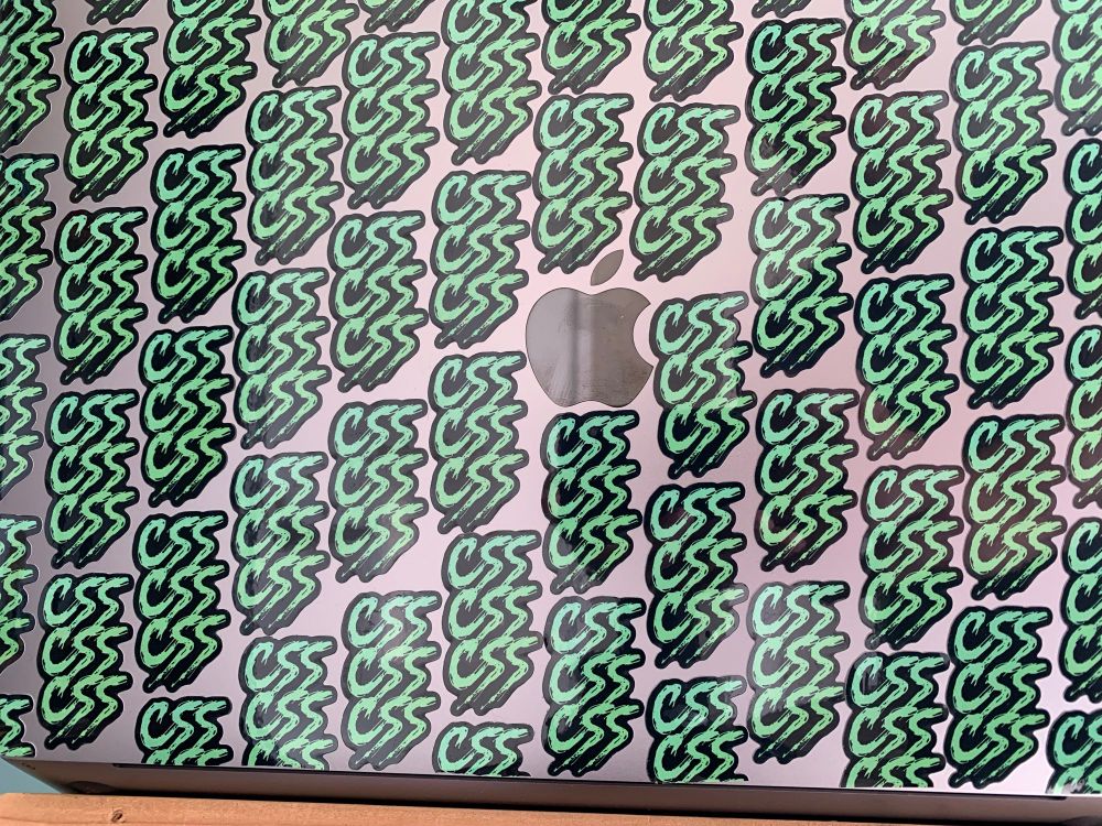 MacBook covered in 64 small stickers of CSS