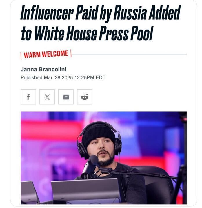 The image is a screenshot of a news article headline that reads: "Influencer Paid by Russia Added to White House Press Pool." The article is labeled with "WARM WELCOME" in red text. It is authored by Janna Brancolini and was published on March 28, 2025, at 12:25 PM EDT. Below the headline, there are social media sharing icons for Facebook, X, email, and Reddit. The accompanying image shows a person wearing a black beanie and large headphones, sitting in front of a microphone and a laptop, with a colorful background featuring shades of red, blue, and purple.
