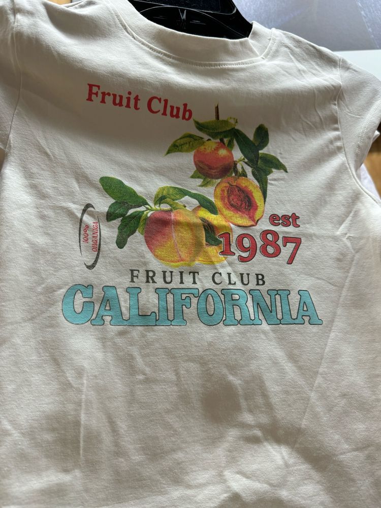 white t shirt with pictures of fruit that says “Fruit Club” and “California”