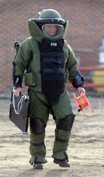 A person wearing a bomb squad explosive protection suit.