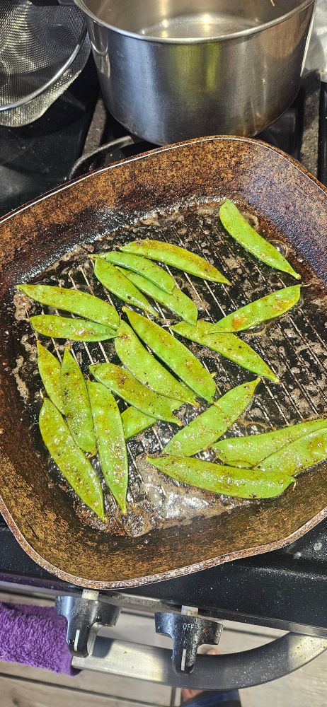 A picture of stir fried snow peas in salted butter, soy sauce and malt seasoning 