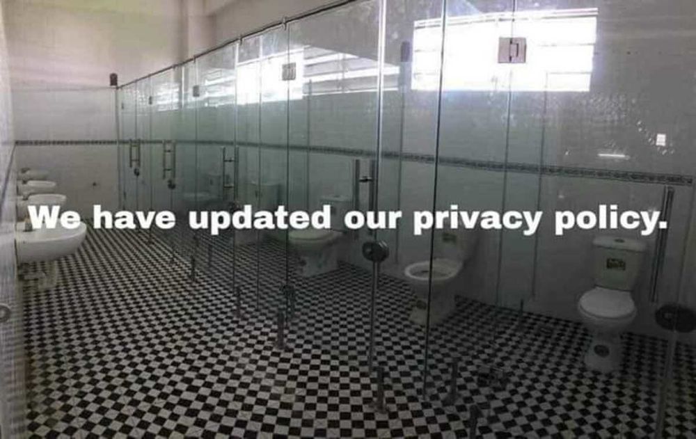 A photograph showing a toilet block, but all of the stalls are made of completely transparent glass.

A text overlay is present, stating "We have updated out privacy policy."