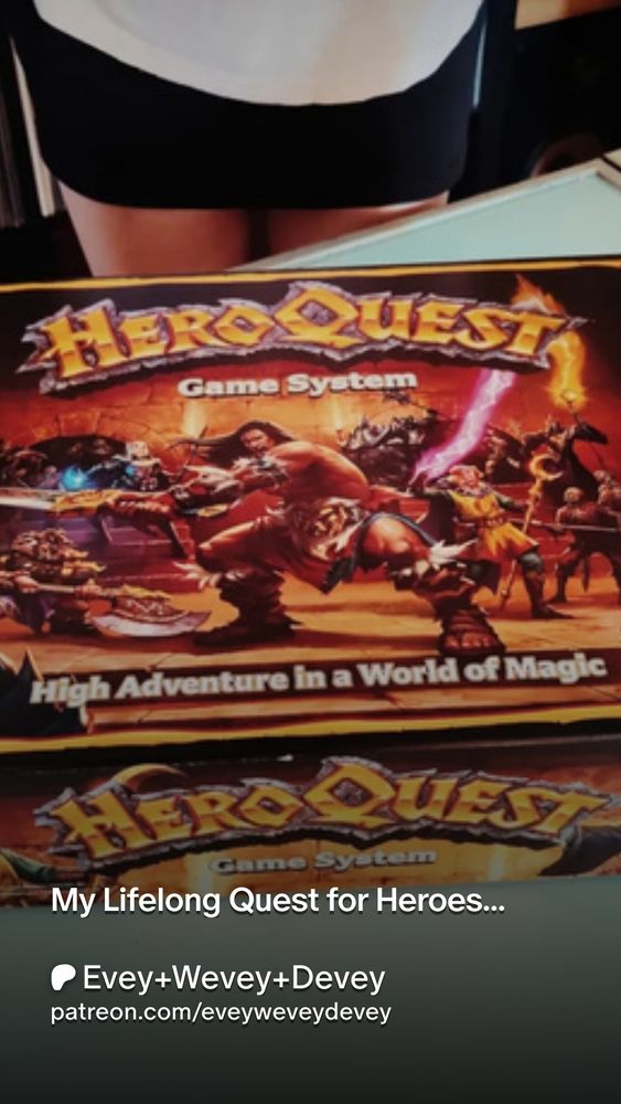 'My Lifelong Quest for Heroes...'
Picture show a gorgeous pair of legs in a miniskirt holding a box of the board game 'HeroQuest'...