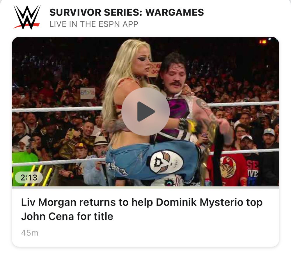 Screenshot from ESPN.com of WWE wrestler Dominik Mysterio holding Liv Morgan with the text of “Liv Morgan returns to help Dominik Mysterio top John Cena for title”