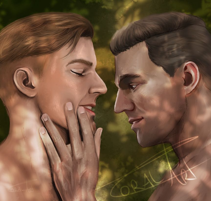 Close-up of Hans and Henry with their heads close together. Henry’s hand is on Hans’s cheek as he looks at his lips, while Hans has his eyes closed. Soft lighting of sun though the trees.