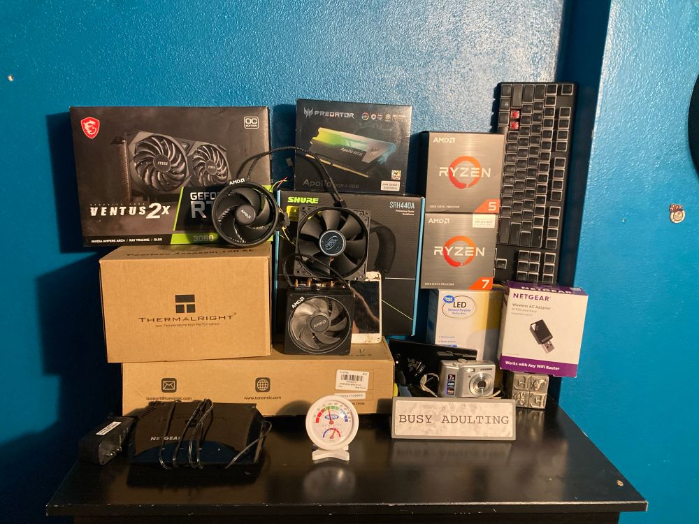 Picture consists of various tech items ranging from computer parts to phones and other smaller electronics 