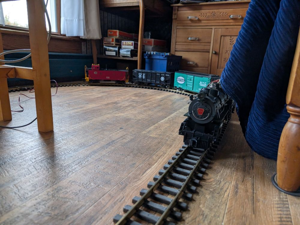 The Atlantic pulling a train made of a New York Central jade green boxcar, an O&W covered hopper and an NYC caboose.