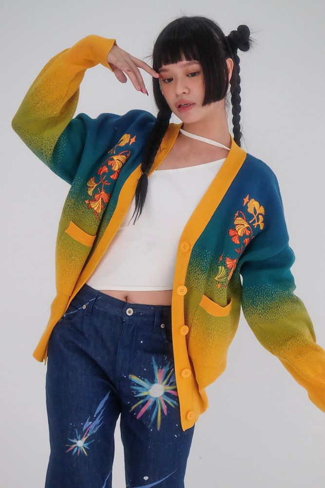 Model wearing blue, green, and yellow gradient cardigan with ginkgo embroideries. 