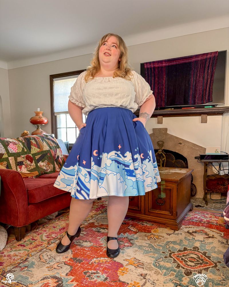 Maya wearing blue midi skirt with wave design. 