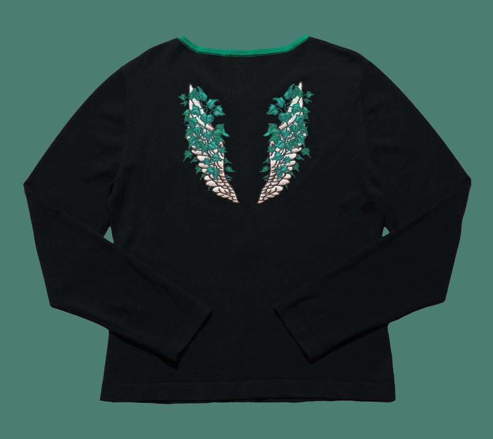 Black henley shirt with the back embroidered with angel wing draped in ivy.