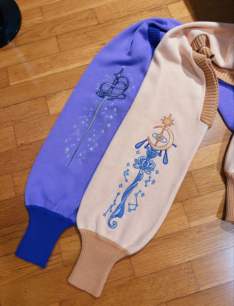 Two knit boleros with sword and magic staff embroideries. 