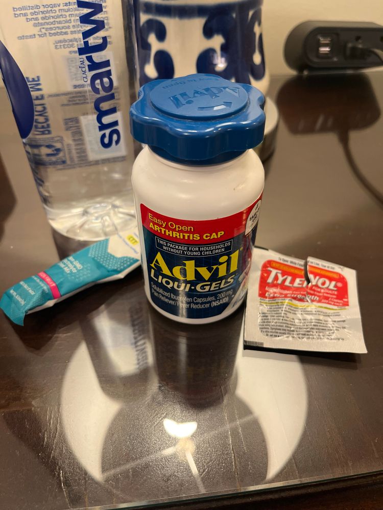 A picture of a water bottle Tylenol advil and hydration powder