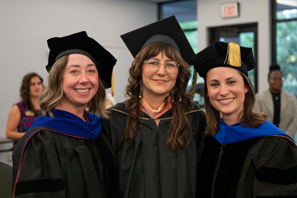 Standing and smiling between my professors and mentors, Dr. Aleta Baldwin and Dr. Jenny Waggner, at my MPH graduation.