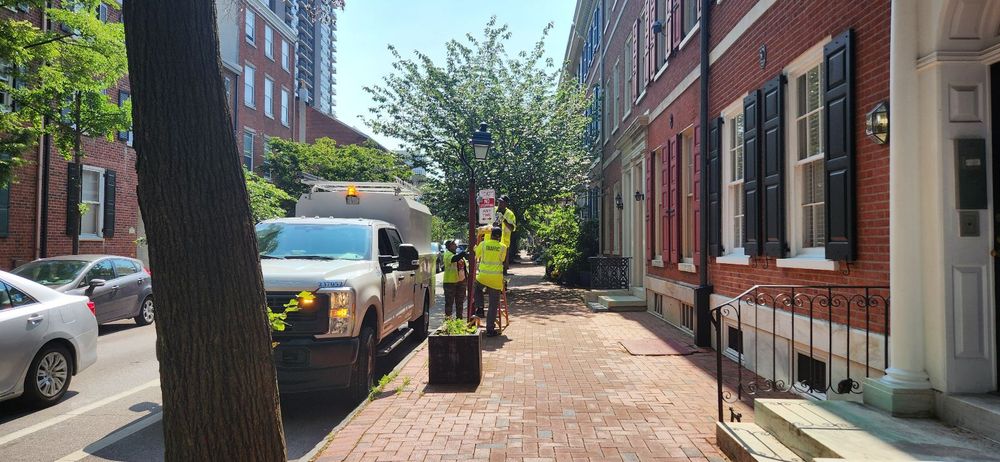 Philadelphia Streets Department workers posting 
"No Stopping" signs on Spruce St June 11, 2025. 

The signs replace "No Parking" signs which allow drivers to park for up to 20 minutes in Philadelphia.