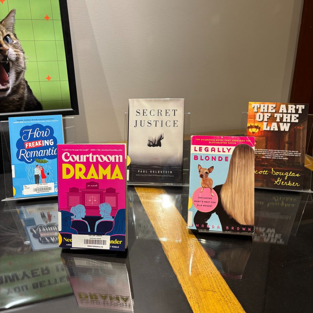 Five books. How Freaking Romantic by Emily Harding, Courtroom Drama by Neely Tubati Alexander, Secret Justice by Paul Goldstein, Legally Blonde by Amanda Brown, and The Art of the Law by Scott Douglas Gerber.