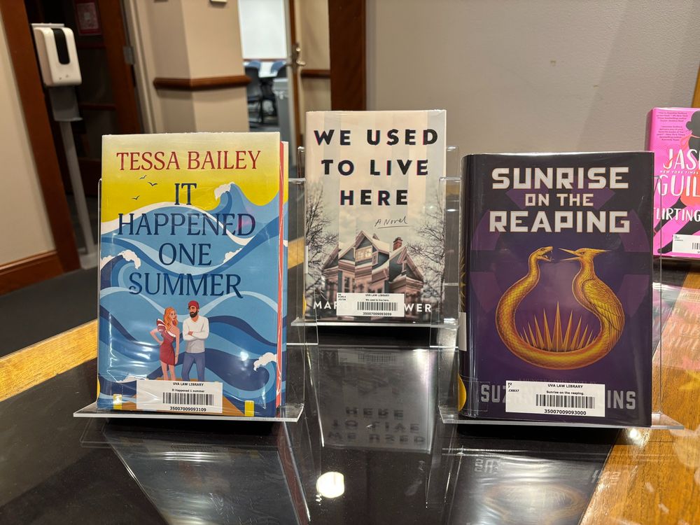 3 books from left to right: It Happened One Summer by Tessa Bailey, We Used to Live Here by Marcus Kliewer, and Sunrise on the Reaping by Suzanne Collins.