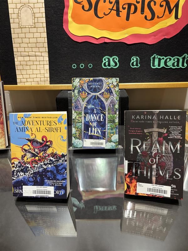 3 books. The Adventures of Amina Al-Sirafi by Shannon Chakraborty, A Dance of Lies by Brittney Arena, and Realm of Thieves by Karina Halle.
