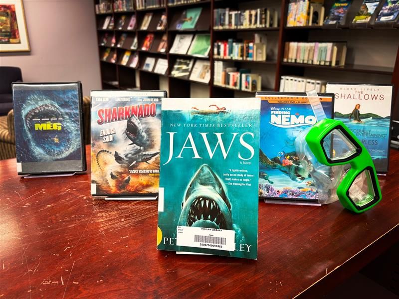 A display featuring iconic DVDs and books about sharks