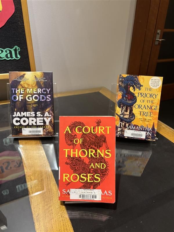 3 books. The Mercy of Gods by James S. A. Corey, A Court of Thorns and Roses by Sarah J. Maas, and Priory of the Orange Tree by Samantha Shannon.
