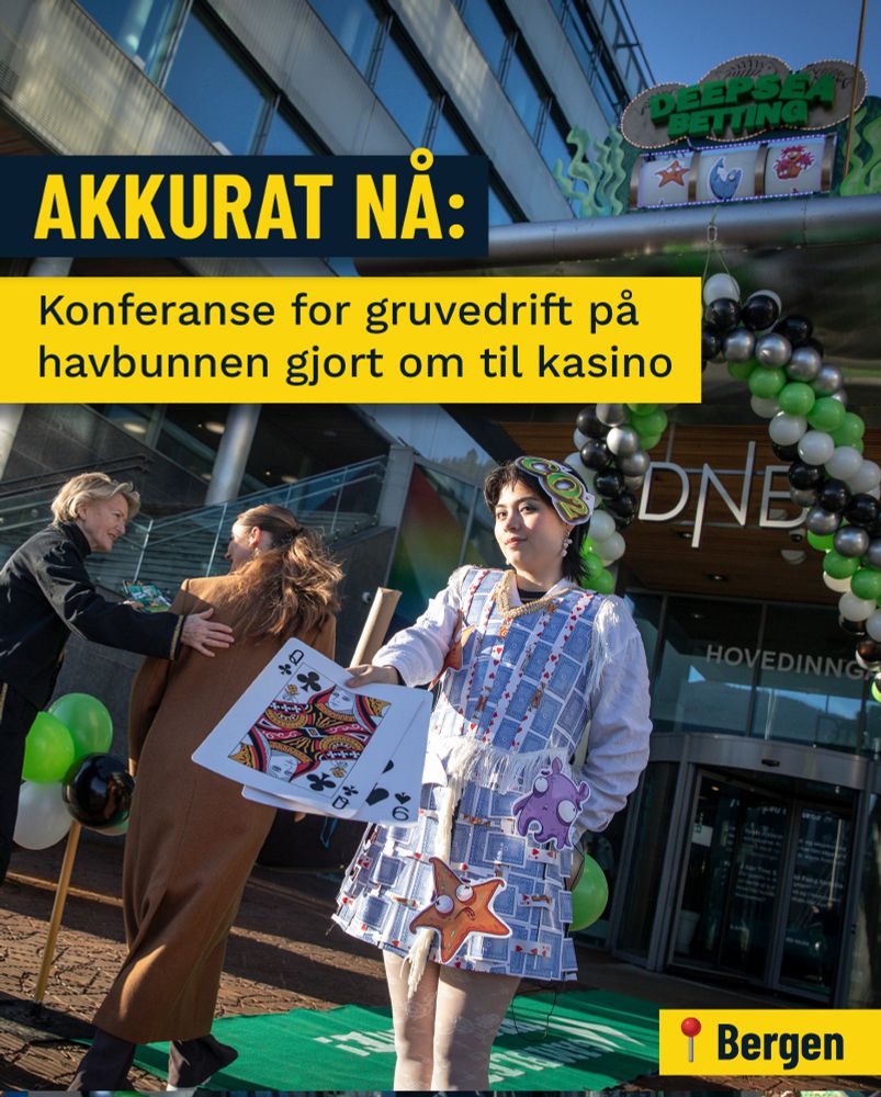 En person i kjole laget av spillkort holder opp store spillkort utenfor et bygg dekorert med ballonger i grønt, svart og hvitt. 

Et skilt i bakgrunnen viser "DEEP SEA BETTING". Til venstre står to  kvinner, den ene i en svart jakke og den andre i en brun kåpe. 

Teksten øverst til venstre lyder "AKKURAT NÅ: Konferanse for gruvedrift på havbunnen gjort om til kasino". Nederst til høyre er det et rødt merke med en hvit pil og teksten "Bergen".
