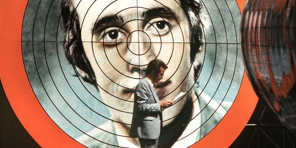 In this striking still from The Million Game, host Thilo Uhlenhorst can be seen in front of an oversized portrait of contestant Bernhard Lotz with crosshairs on his face.