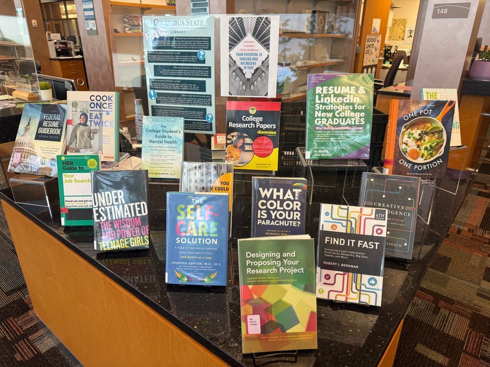 Large tabletop display of books about careers and college success. Sign says "Your potential is endless and we believe in you!"