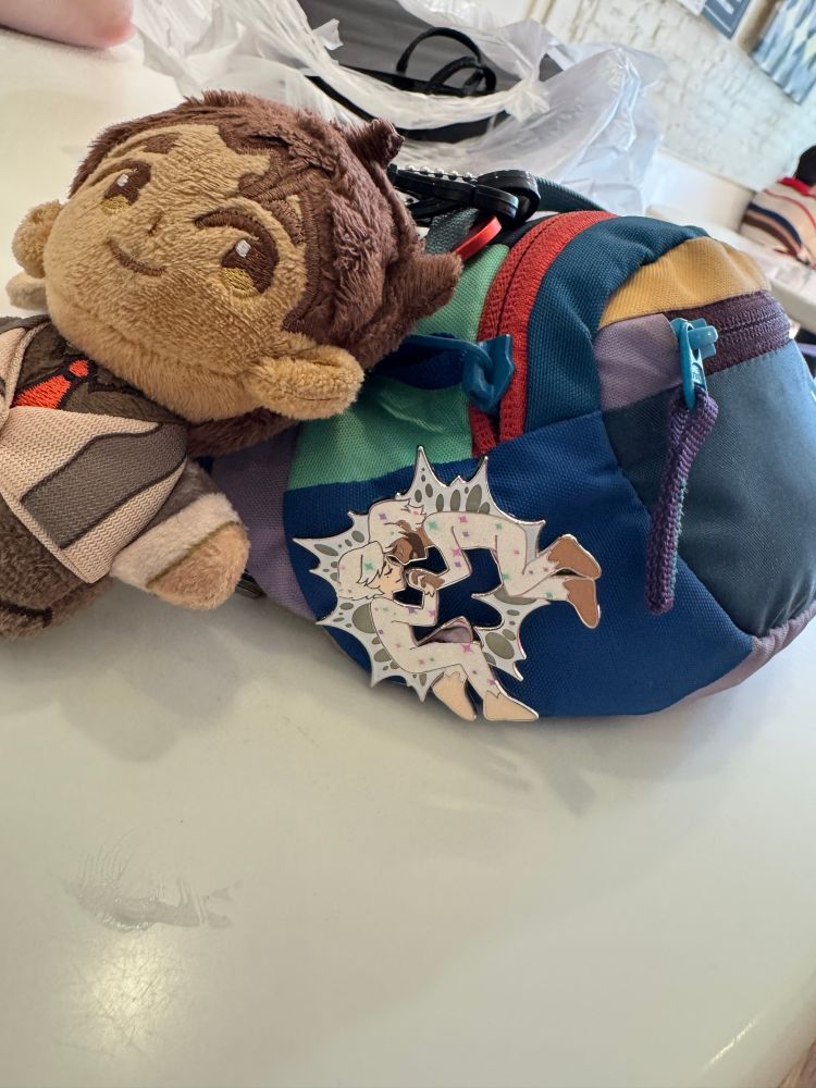 Jayce stuffie and a jayvik pin on a Cotopaxi bag
