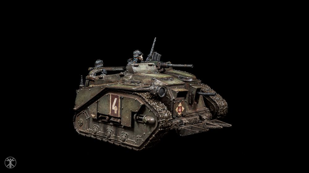 Front view of a weathered green miniature Death Korps of Krieg assault troop carrier for Warhammer 40K.