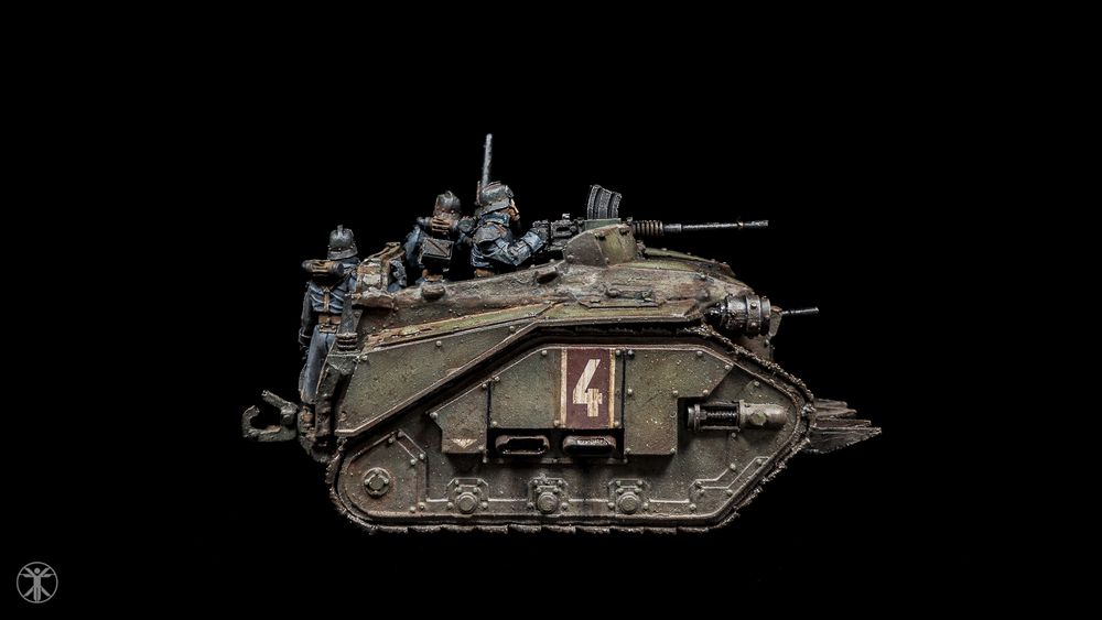 Side view of a weathered green miniature Death Korps of Krieg assault troop carrier for Warhammer 40K.