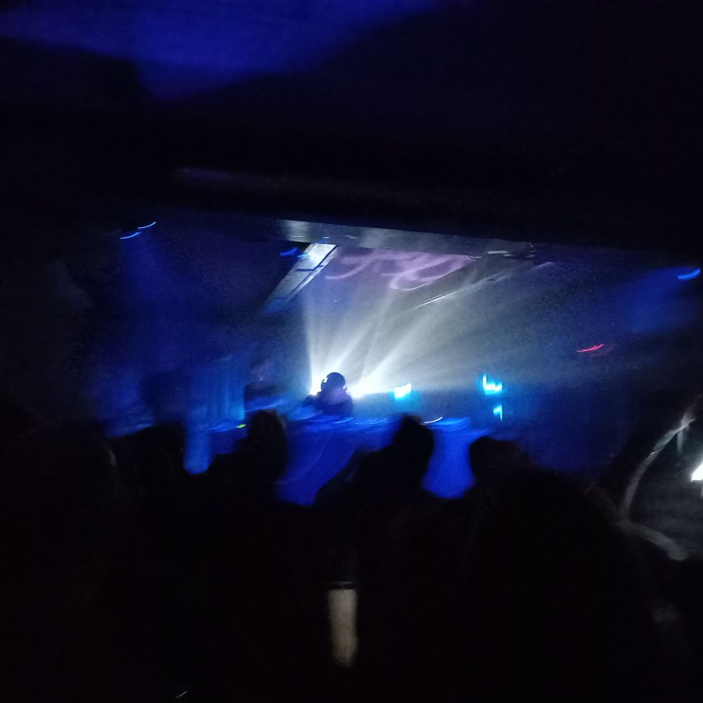 a blurry photo of a rave, in white and blue light