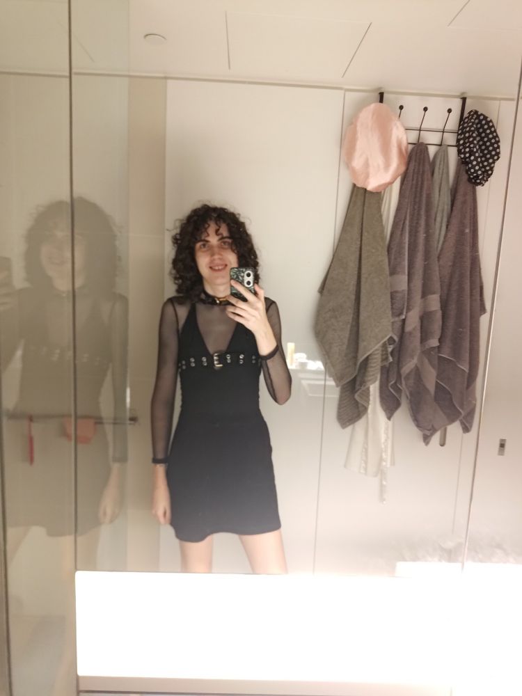 Same collar and mesh shirt as before but now with a halter top that has an included belt and a black skirt 