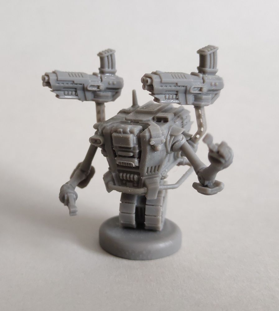Wargames miniature - a tracked robot with four arms, front view.