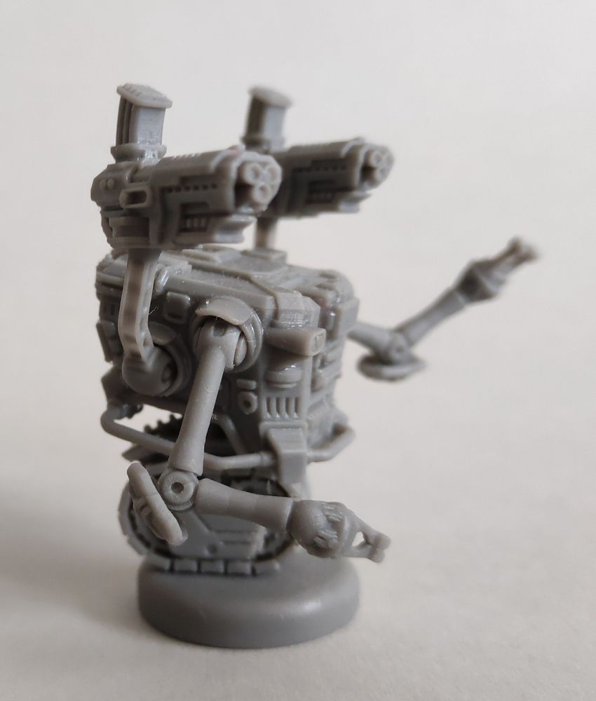 Wargames miniature - a tracked robot with four arms, side view.