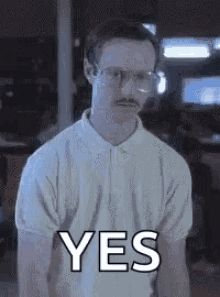 a man with glasses and a mustache is wearing a white shirt and says yes .