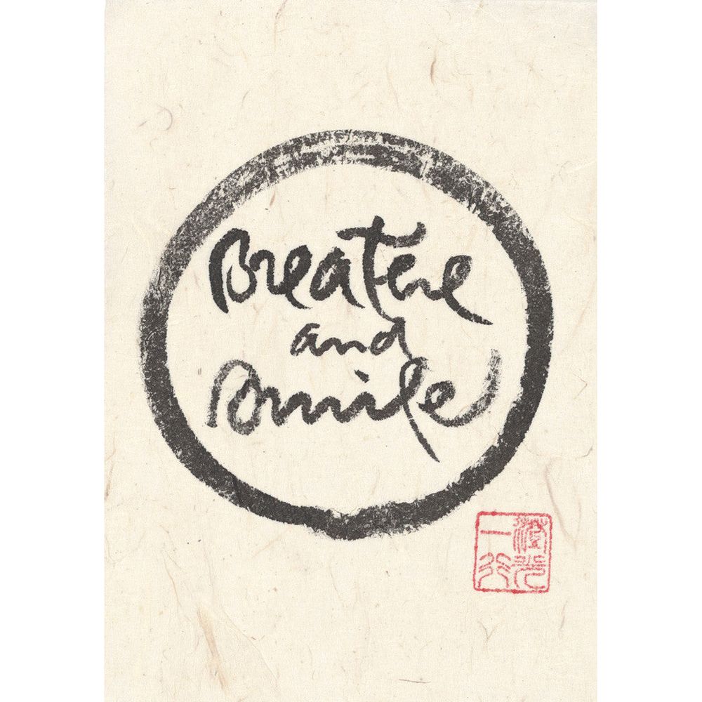 Black Calligraphy on white rice paper which reads “Breathe and smile” the words are in written in the centre of a circle. This circle is called an Ensō which is the visual expression of enlightenment and emptiness. Thay would have begun at the bottom middle and drawn clockwise, breathing in and then breathing out at the top of the circle to continue round. In the bottom right corner is a red stamp/seal this is his lineage name and Dharma title, which translates to "Nhat Hanh, the Light of the Middle". 
Thays calligraphies act as a “bell of mindfulness” reminding us to arrive in the here and now, and touch the wonders of life.
To breathe and smile.
