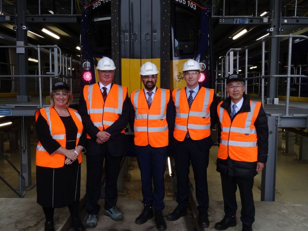 Karen Boswell (left) and Humza Yousaf (middle) as part of Hitachi/Scottish Govt delegation in front of 385103 